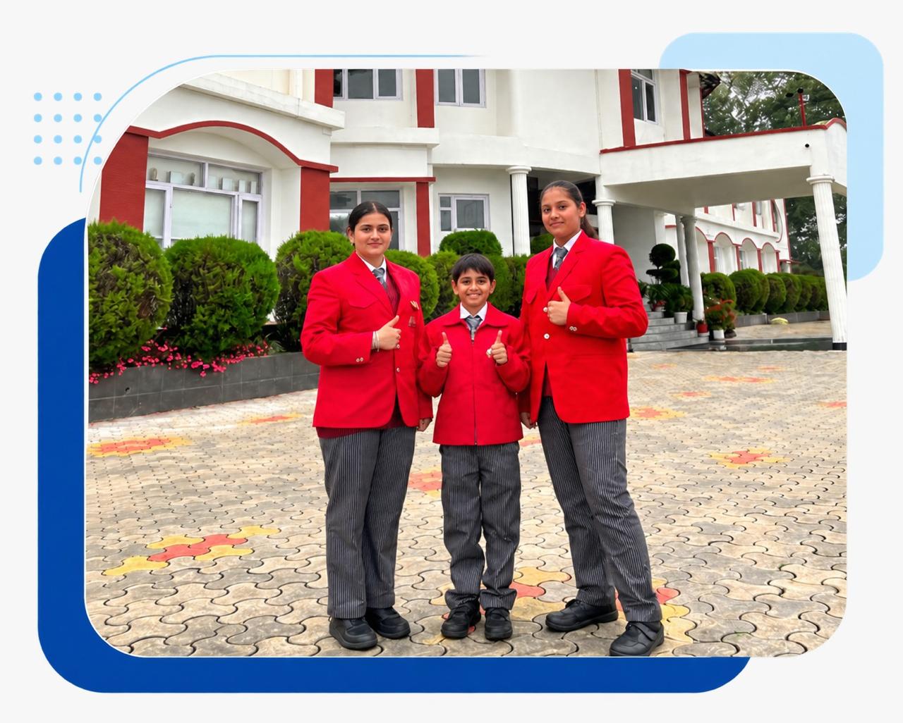 Three students in red G.D. Goenka school uniforms outside the Nainital campus